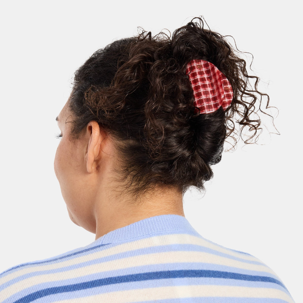 Woman with thick curly hair wearing the Chunks Juno Hair Claw Clip in Red Plaid
