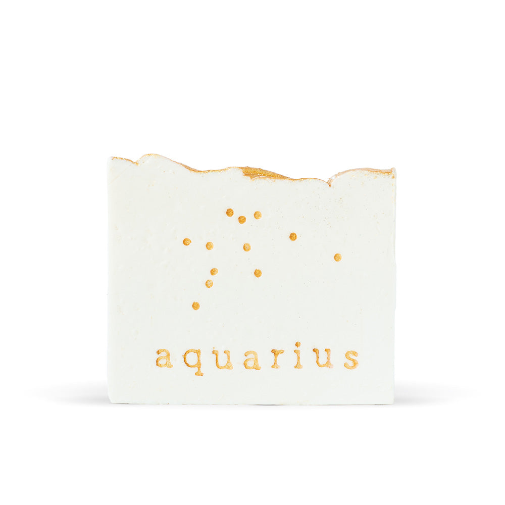 Finchberry Lily & Ginger Aquarius Bar Soap is white with natural gold glitter detailing of the Aquarian constellation and type reading "aquarius."