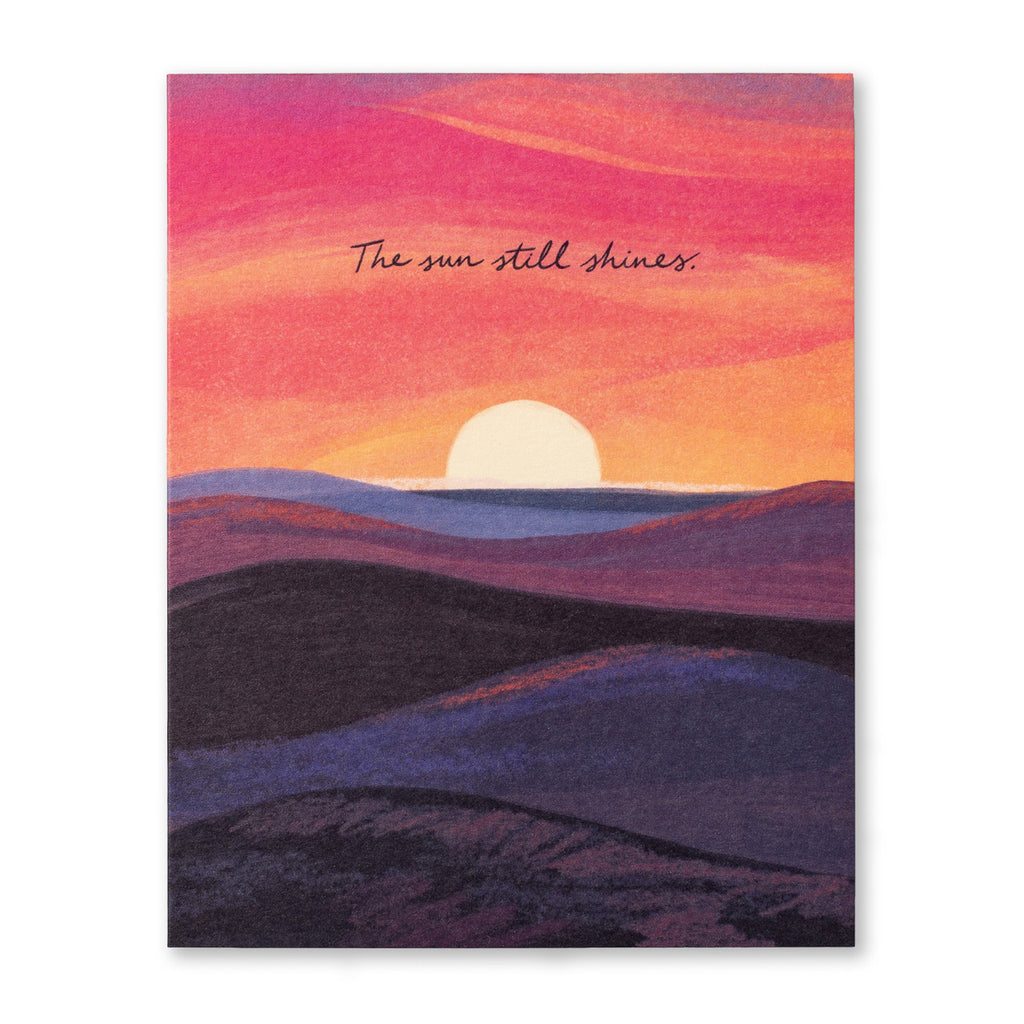 Tough Times Greeting Card - The Sun Still Shines. Illustration shows a sunrise over the horizon of rolling hills and landscape. The sky is bright oranges and pinks.