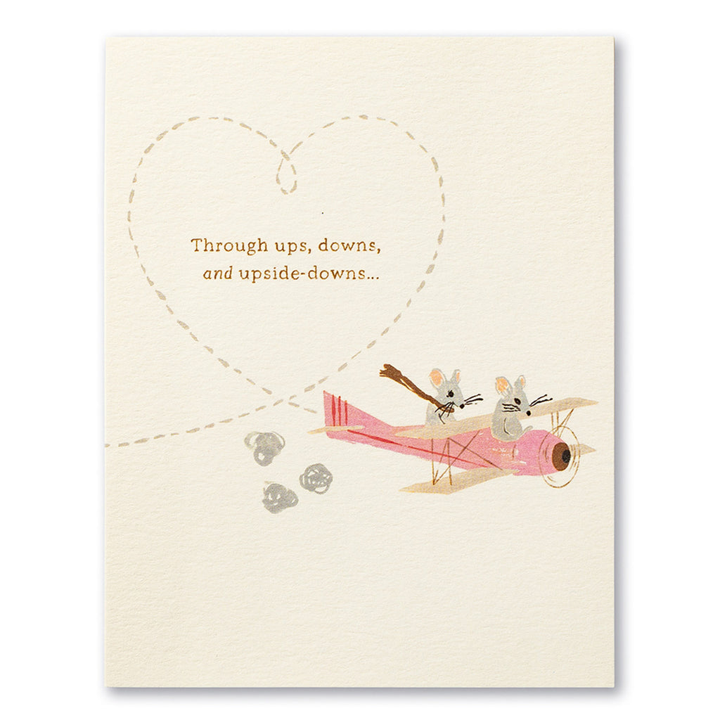 Anniversary Greeting Card - Through Ups, Downs, and Upside Downs. Illustration shows a pink airplane being flown by two mice creating a heart shape in the sky.