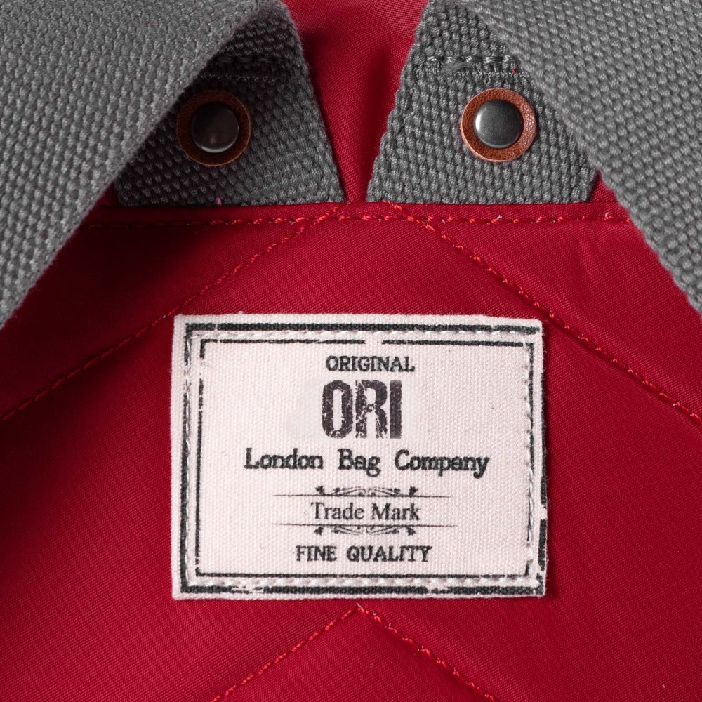 Ori London Bantry B Small Sustainable Recycled Nylon Backpack Cranberry Original Ori London Bag Company Trade Mark Label Close Up