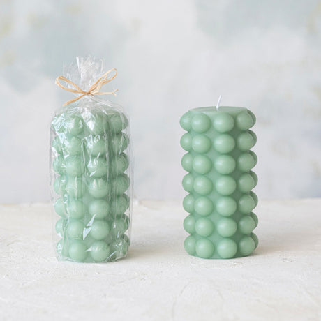 Unscented Hobnail Pillar Candle 6"H in Mint Green shown in cellophane packaging and without.