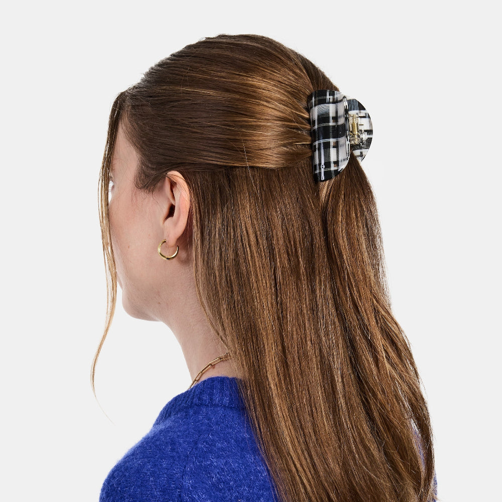 Person with the Chunks Juno Black and White Plaid Hair Claw Clip in a Half Up Half Down Hairstyle on a white background