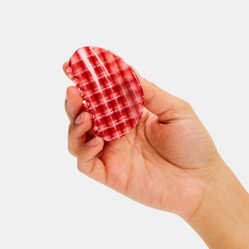 A hand holding the Chunks Juno Hair Claw Clip in Red Plaid on a white background