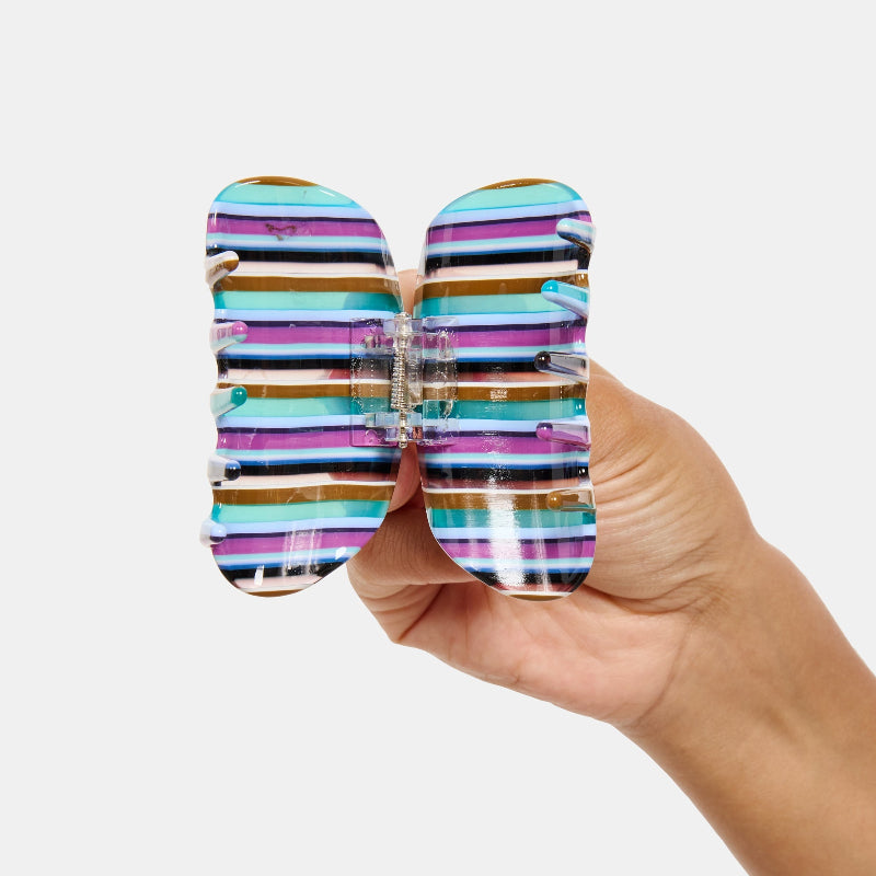 Hand holding the Chunks Juno Hair Claw Clip in Frances open on a white background