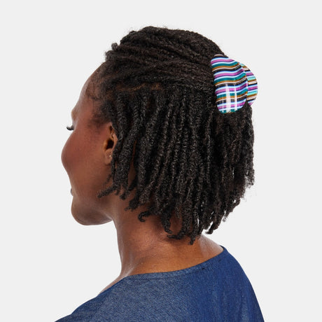 Woman with a half up half down hairstyle wearing the Chunks Juno Hair Claw Clip in the striped Frances colorway