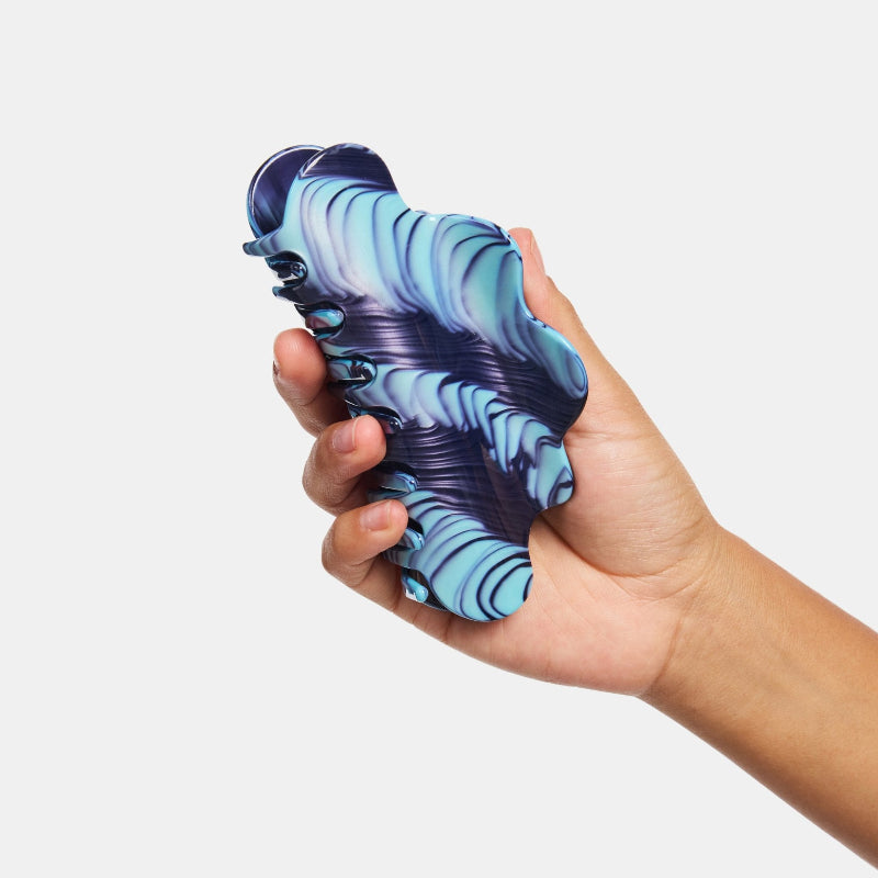 Hand holding Chunks Nimbus Hair Claw Clip in Ripple on white background