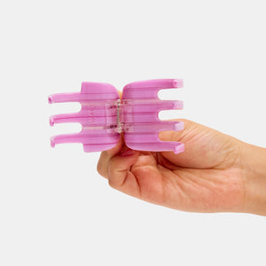 Hand holding Chunks Hair Claw Clip in Petunia Multicolor Striped Pink open on a white background