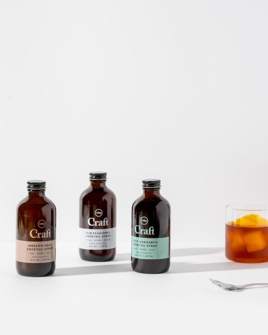 Lifestyle Photo of Old Fashion Cocktail Syrup, Moscow Mule Cocktail Syrup, and Spicy Margarita Cocktail Syrup