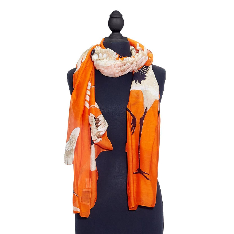 Great Heron Lightweight Printed Scarf in Tangerine Orange on mannequin