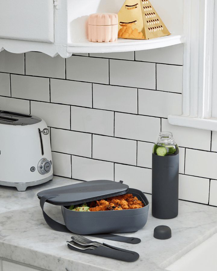 w&p porter lunchbox in charcoal grey shown in kitchen lifestyle image